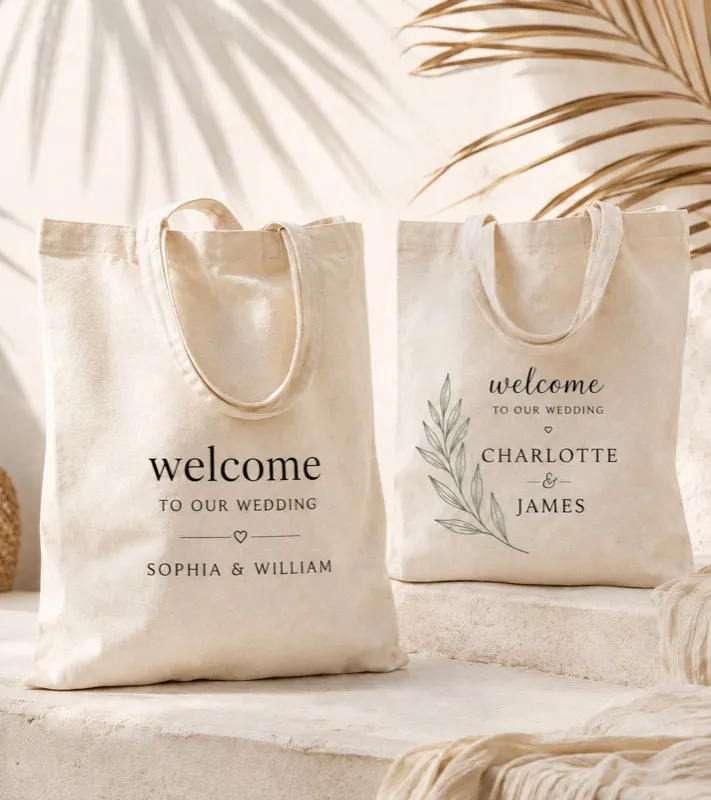 Two printed totes side by side — one pressed in a single ink, the other with a green sprig beside the names